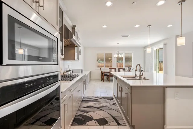 a kitchen with stainless steel appliances granite countertop a sink and stove