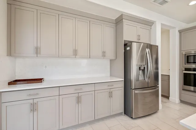 a kitchen with cabinets and stainless steel appliances