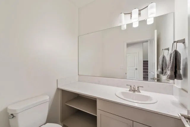 a bathroom with a sink vanity and a mirror