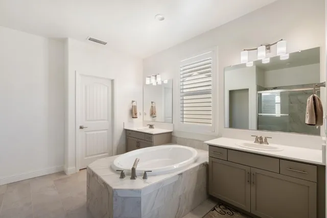 a bathroom with a double vanity sink mirror and double