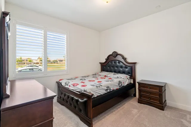 a bed sitting in a bedroom next to a window