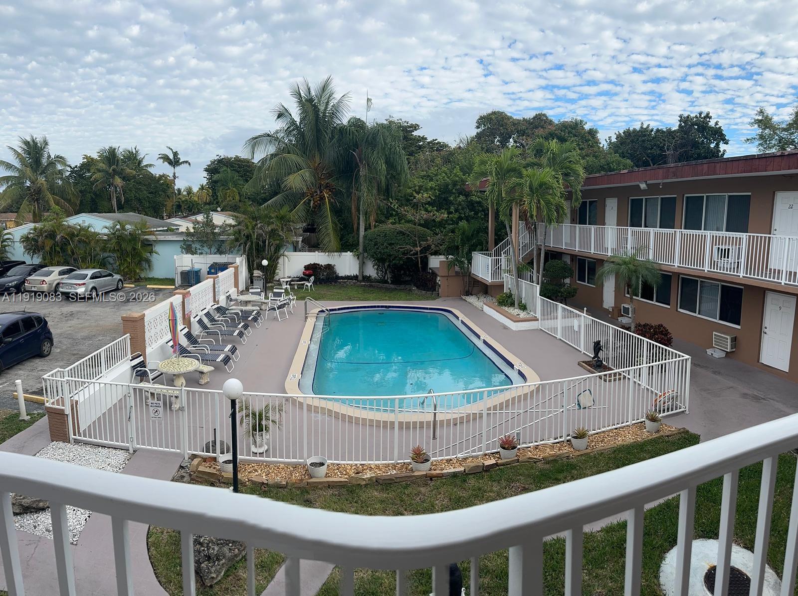 2838 Madison Street, Unit 19 Hollywood, FL 33020 - Photo 1 of 5 a view of a patio with swimming pool