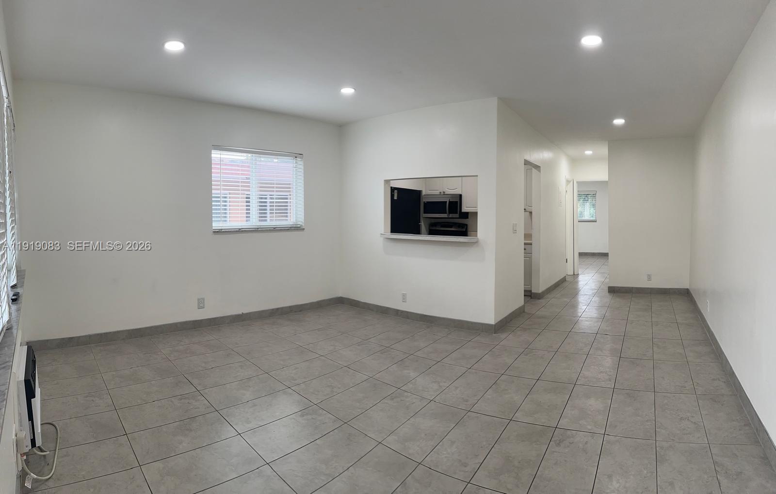 2838 Madison Street, Unit 19 Hollywood, FL 33020 - Photo 2 of 5 an empty room with white walls and washer