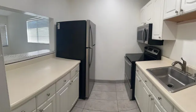 a kitchen with a refrigerator sink and stove
