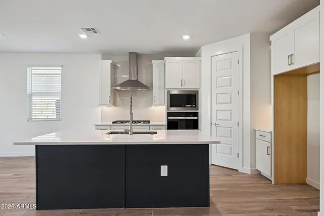 a kitchen with stainless steel appliances a sink stove and refrigerator