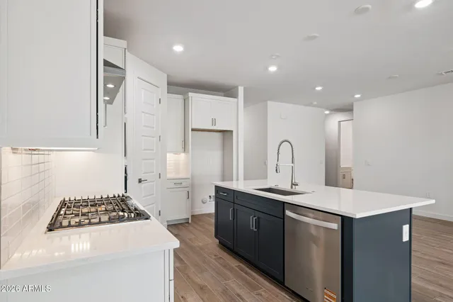 a kitchen with sink a stove and refrigerator