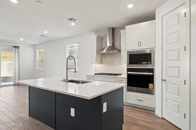 a kitchen with a sink a stove and cabinets