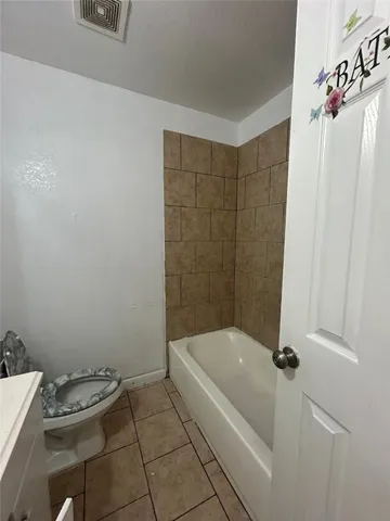 a bathroom with a bathtub and toilet