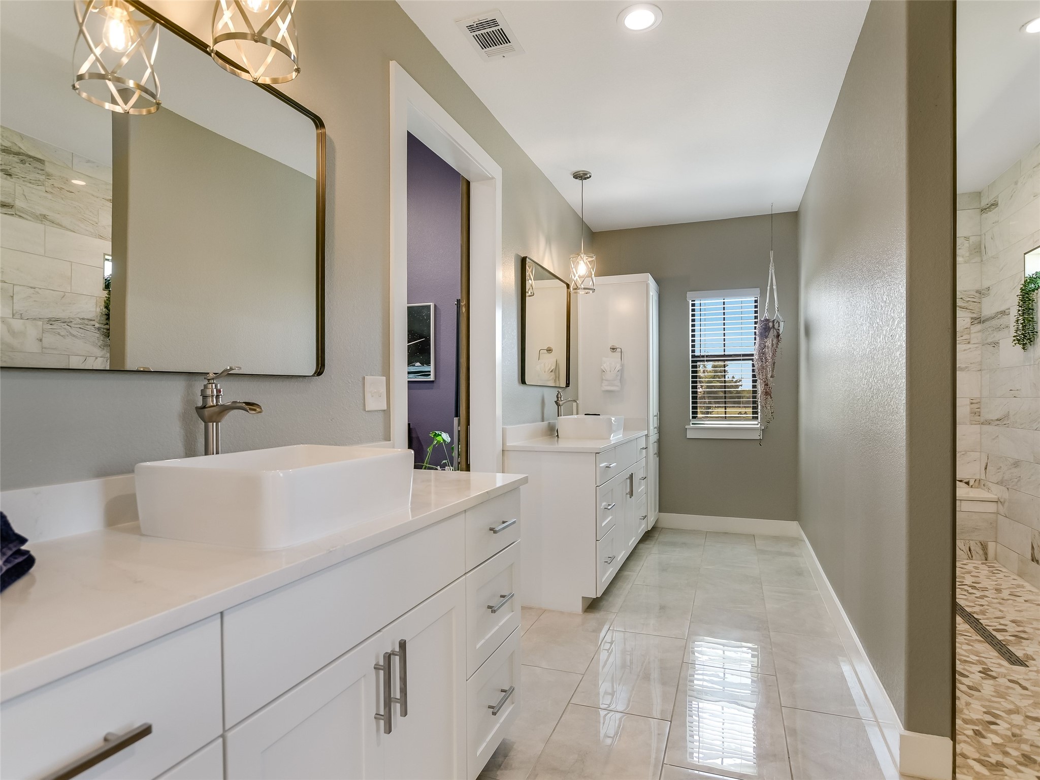 19819 Lockwood Road Manor, TX 78653 - Photo 12 of 29 Morning routines feel indulgent in this spa-inspired bath, where timeless finishes and dual vanities cater to both comfort and convenience.