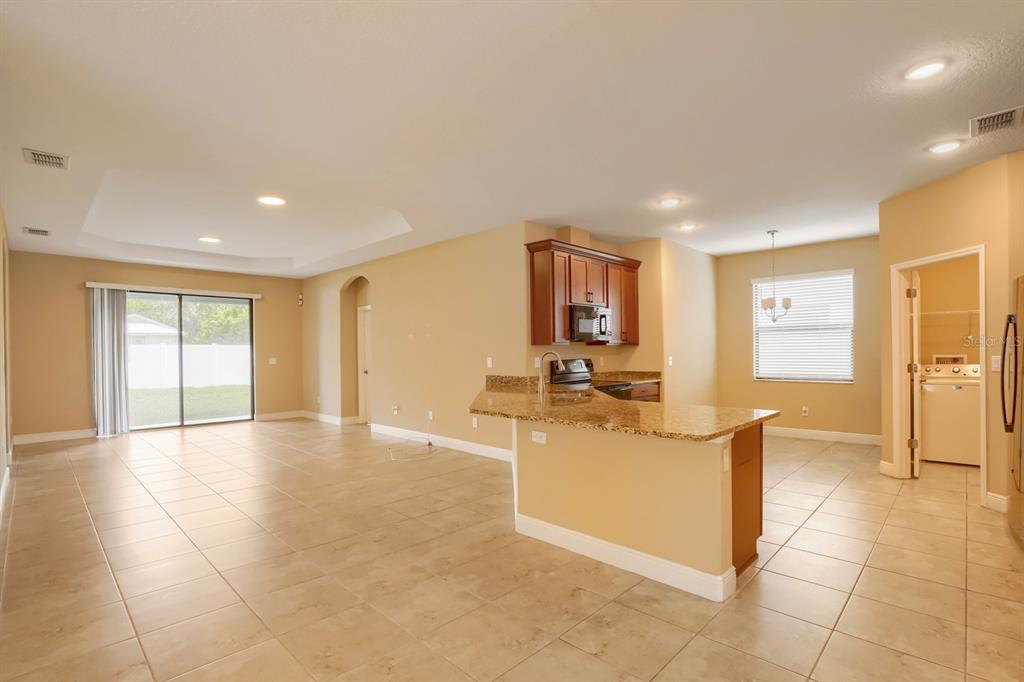 12690 Vander Way New Port Richey, FL 34654 - Photo 5 of 22 a view of a livingroom with furniture and a kitchen