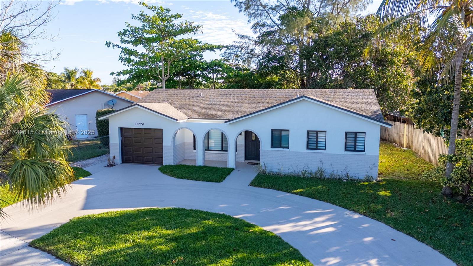 22274 Southwest 61st Avenue Boca Raton, FL 33428 - Photo 54 of 60 a front view of house with yard and green space