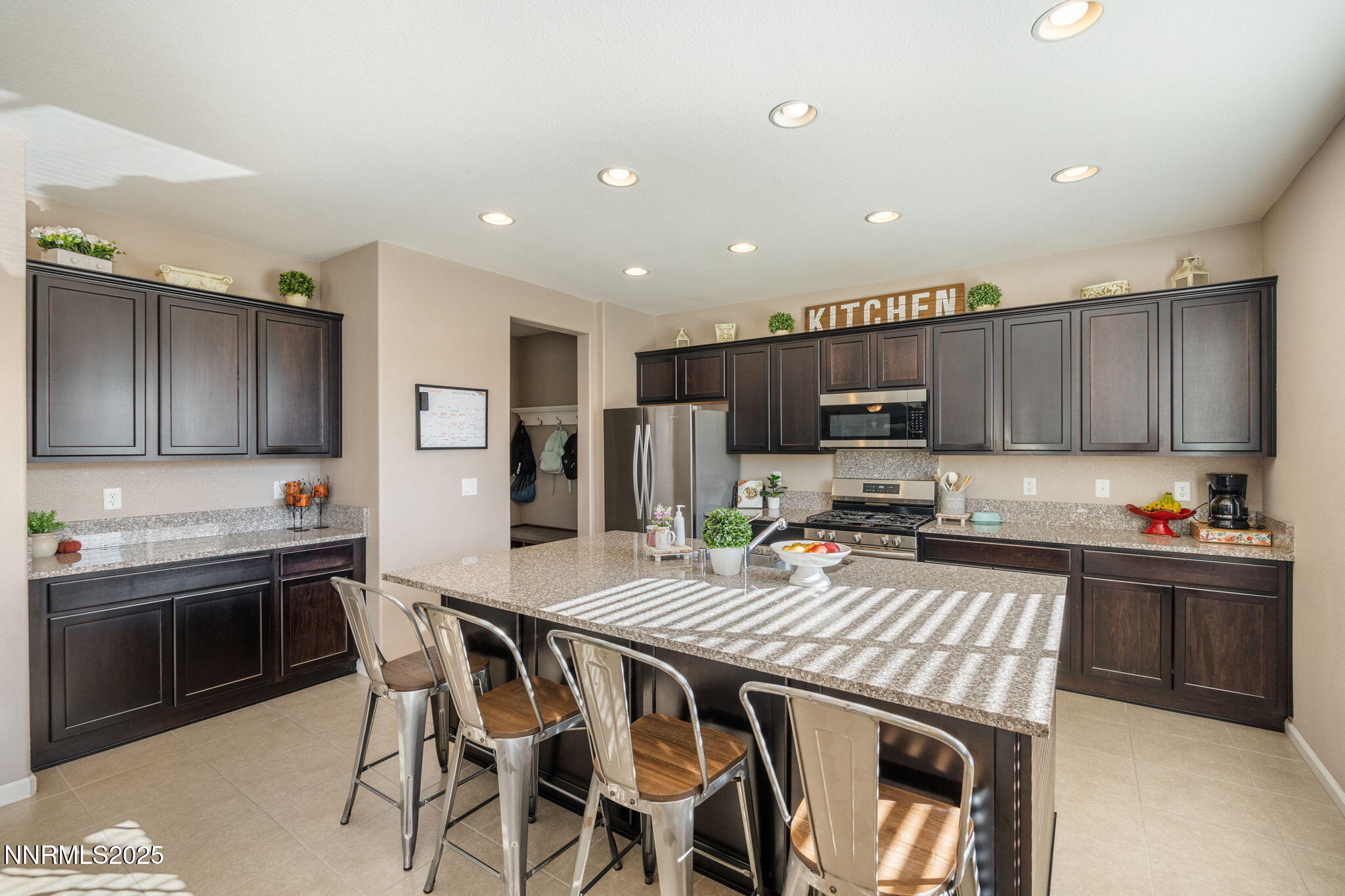 3090 Show Jumper Lane Reno, NV 89521 - Photo 11 of 42 a kitchen with stainless steel appliances granite countertop a stove a sink a microwave a refrigerator and cabinets