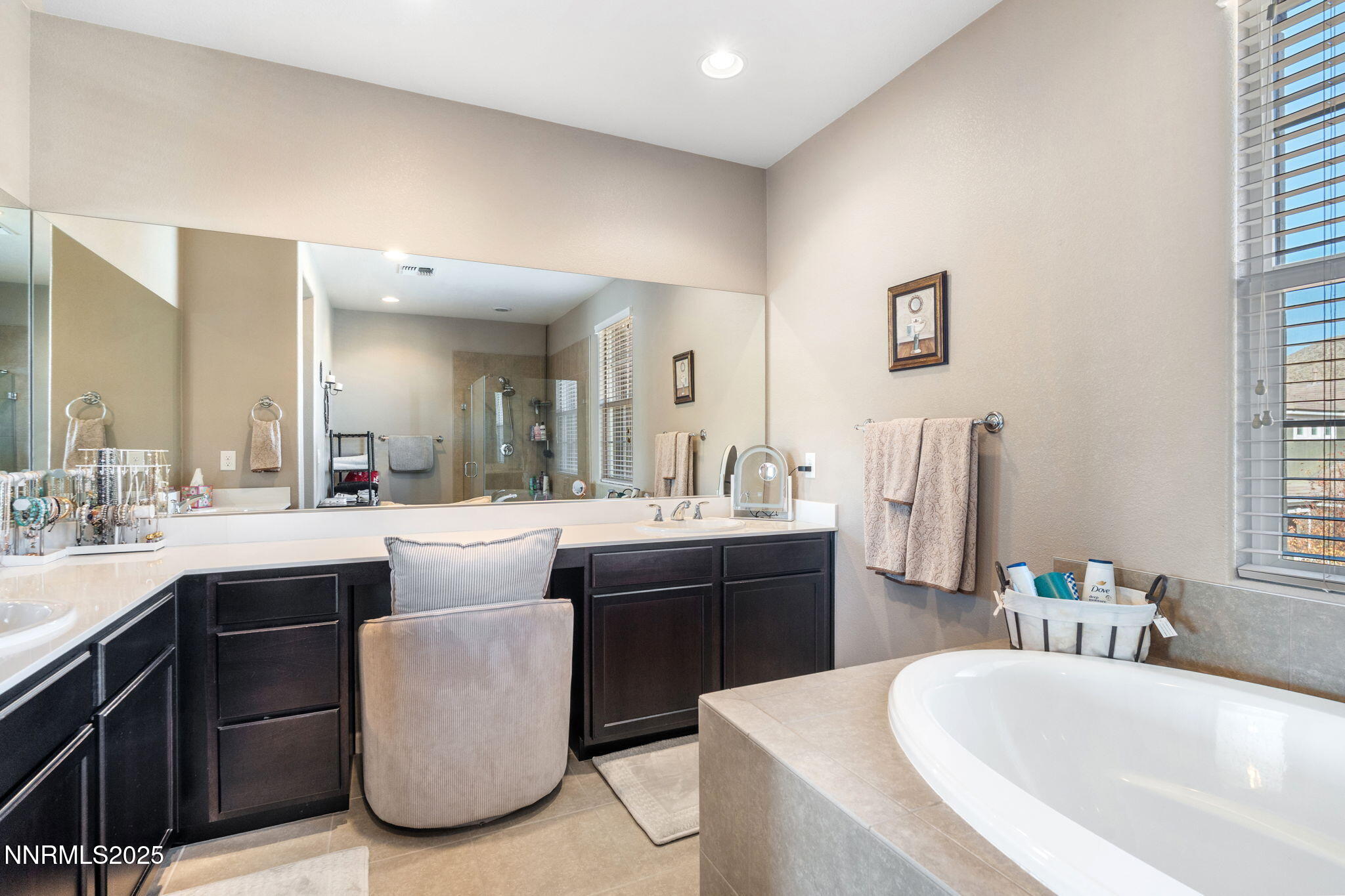3090 Show Jumper Lane Reno, NV 89521 - Photo 27 of 42 a large bathroom with a double vanity sink a mirror and a bathtub
