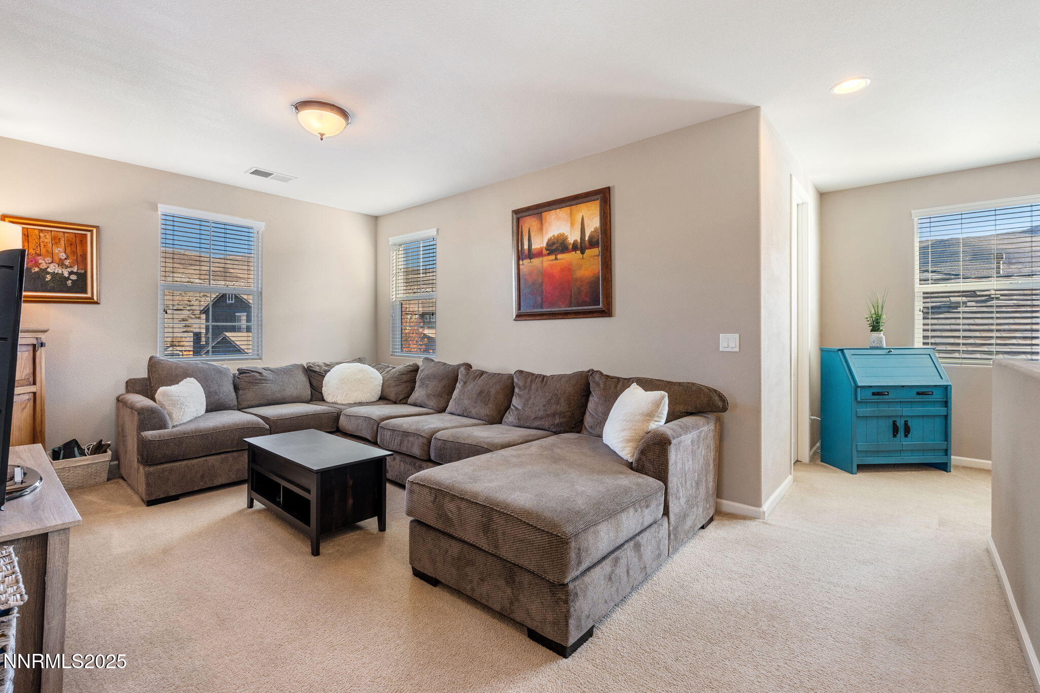3090 Show Jumper Lane Reno, NV 89521 - Photo 29 of 42 a living room with furniture and a flat screen tv