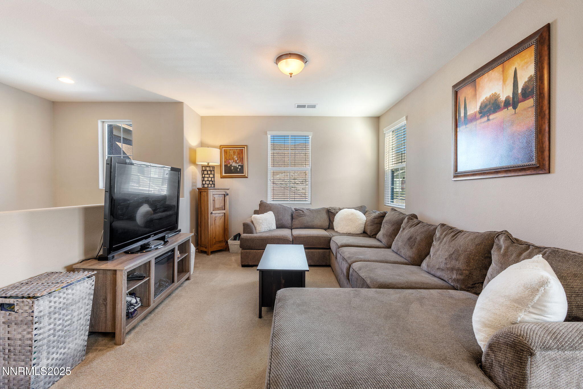 3090 Show Jumper Lane Reno, NV 89521 - Photo 30 of 42 a living room with furniture and a flat screen tv