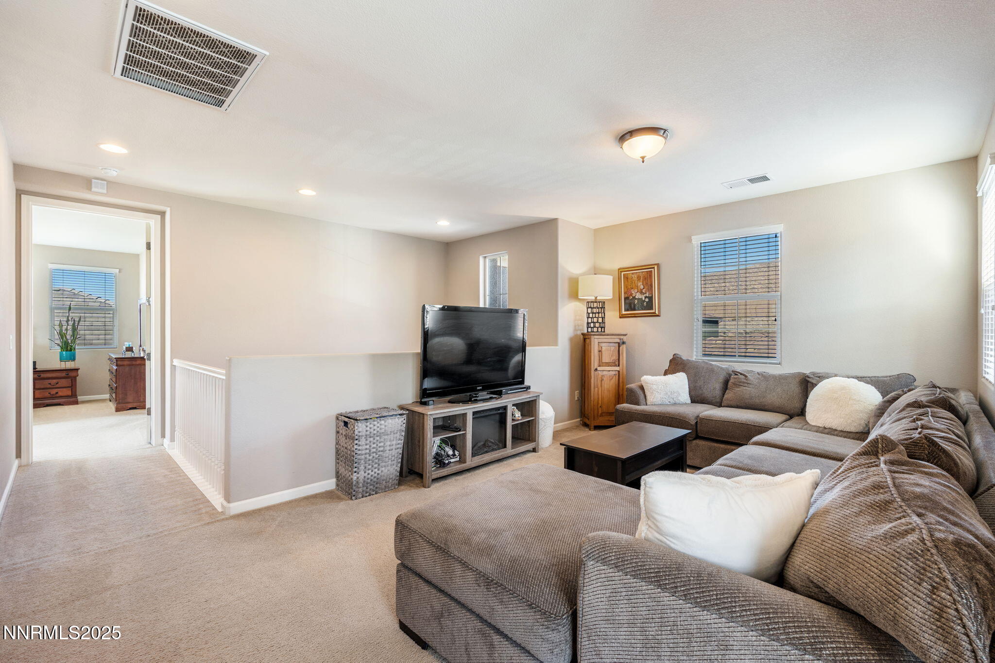 3090 Show Jumper Lane Reno, NV 89521 - Photo 31 of 42 a living room with furniture and a flat screen tv
