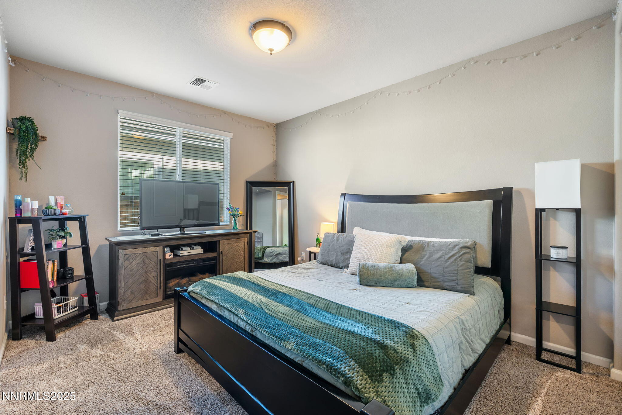 3090 Show Jumper Lane Reno, NV 89521 - Photo 35 of 42 a bedroom with a bed and a flat screen tv