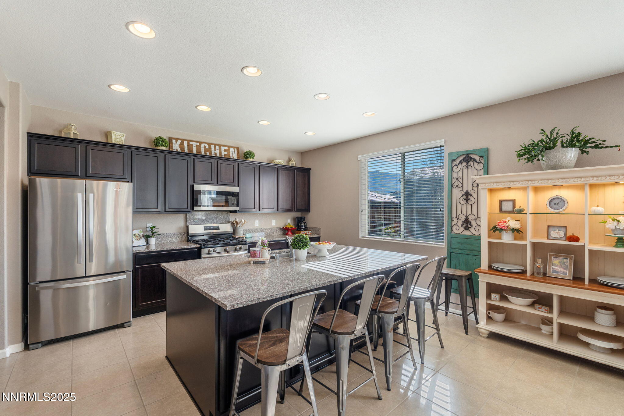 3090 Show Jumper Lane Reno, NV 89521 - Photo 10 of 42 a kitchen with stainless steel appliances granite countertop a stove a refrigerator a sink a dining table and chairs
