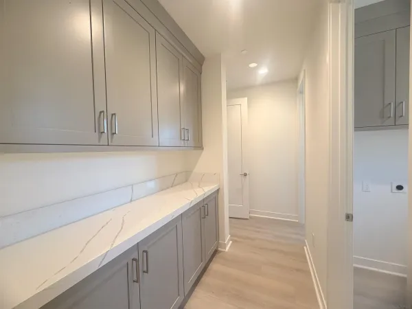 a view of a kitchen with white cabinets