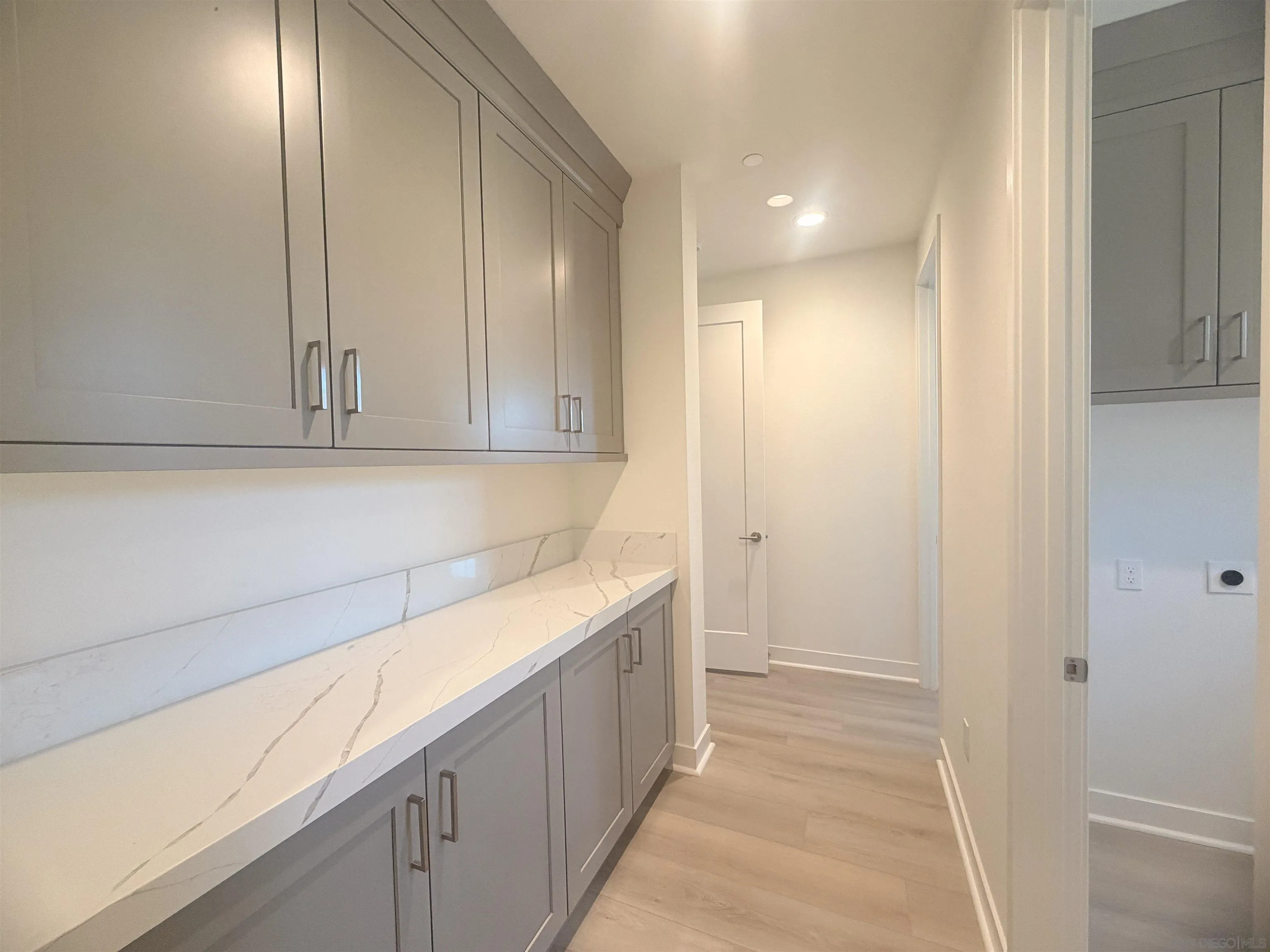 13765 Holly Oak Way Poway, CA 92064 - Photo 18 of 31 a view of a kitchen with white cabinets