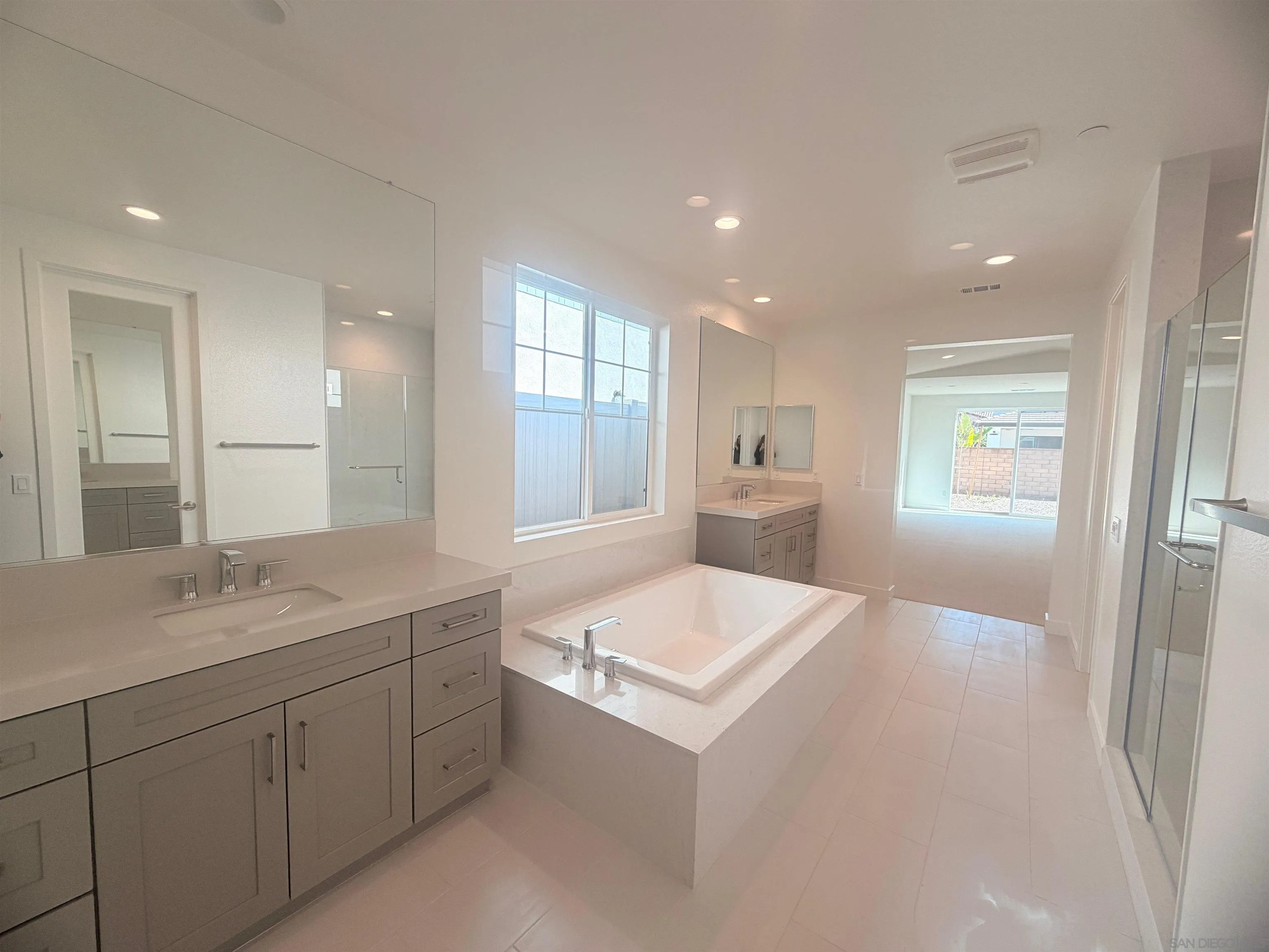13765 Holly Oak Way Poway, CA 92064 - Photo 21 of 31 a large white room with a sink large mirror and cabinets