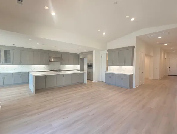 a view of a kitchen with a sink stainless steel appliances and cabinets