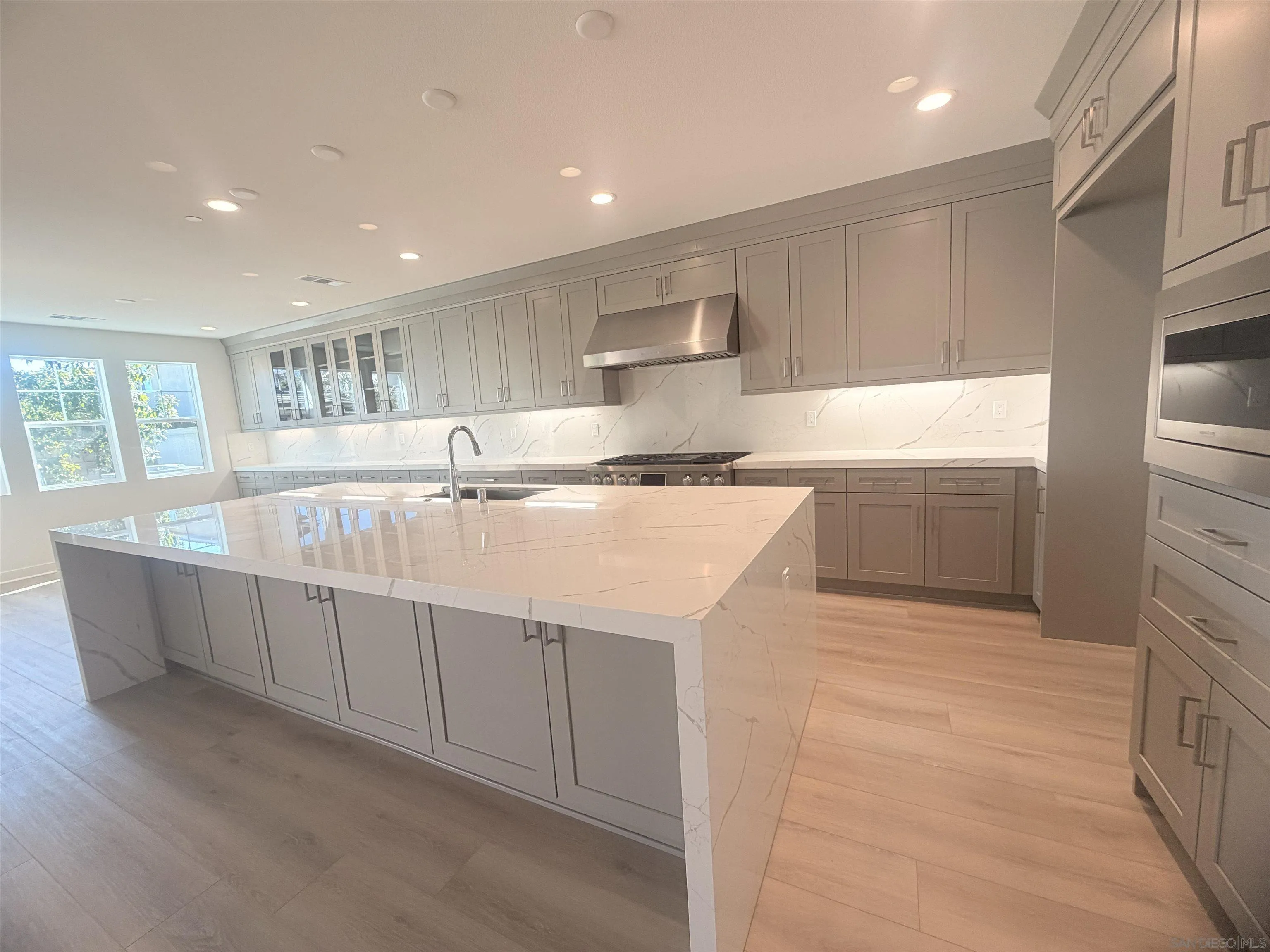 13765 Holly Oak Way Poway, CA 92064 - Photo 7 of 31 a kitchen with stainless steel appliances granite countertop a sink and a refrigerator