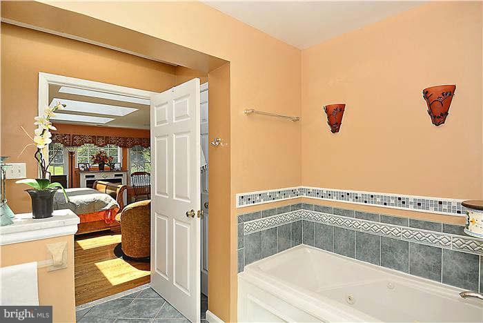8620 Brickyard Road Potomac, MD 20854 - Photo 14 of 30 a white bath tub sitting next to a bathroom