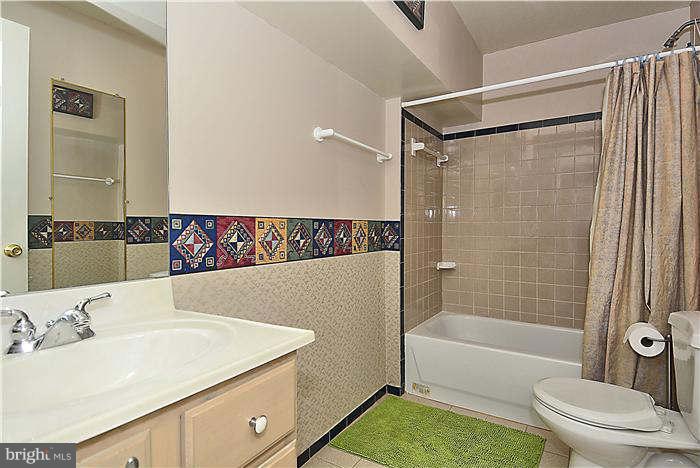 8620 Brickyard Road Potomac, MD 20854 - Photo 22 of 30 a bathroom with a sink and a mirror