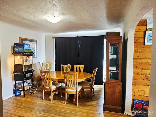 a view of a dining room with furniture and wooden floor