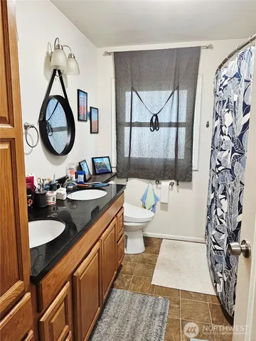 a bathroom with a double vanity sink and a mirror