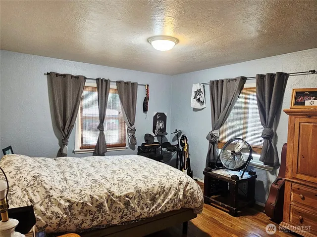 a bedroom with a bed and a flat tv screen