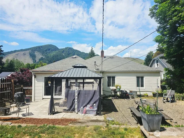 a view of a house with backyard porch and sitting area