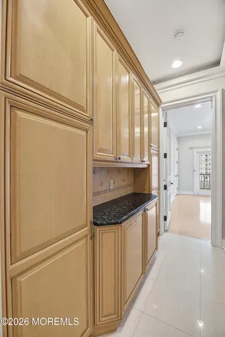 a bathroom with a granite countertop toilet and a sink