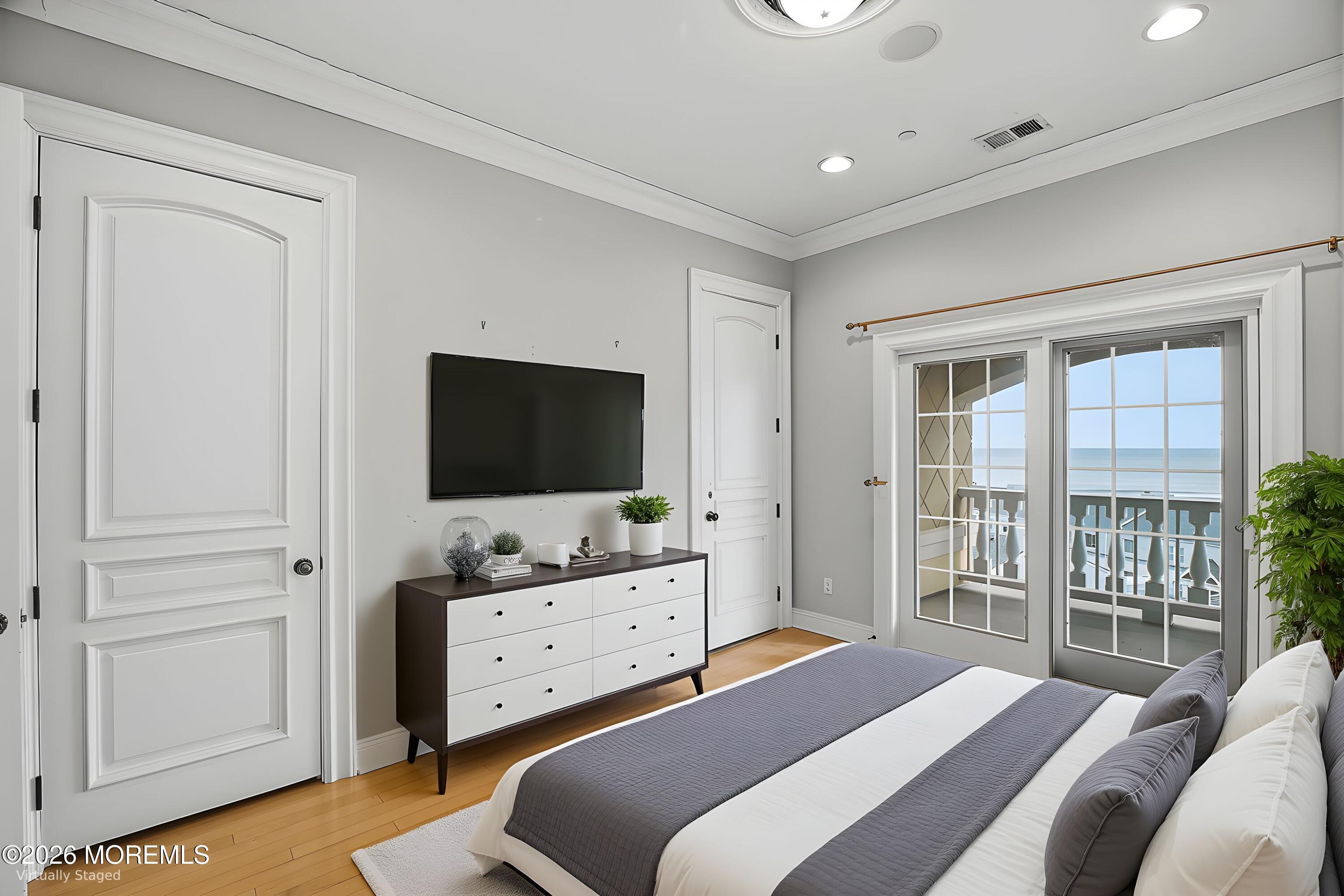 141 Riviera Drive Long Branch, NJ 07740 - Photo 23 of 41 a bedroom with a bed and a flat tv screen in it