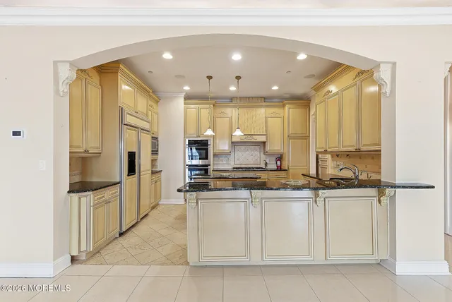 a kitchen with a stove a sink and a refrigerator