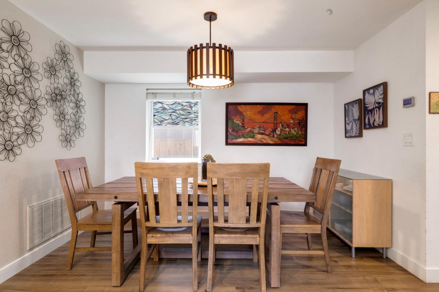 174 Pacific Avenue Pacifica, CA 94044 - Photo 12 of 31 a view of a dining room with furniture and wooden floor