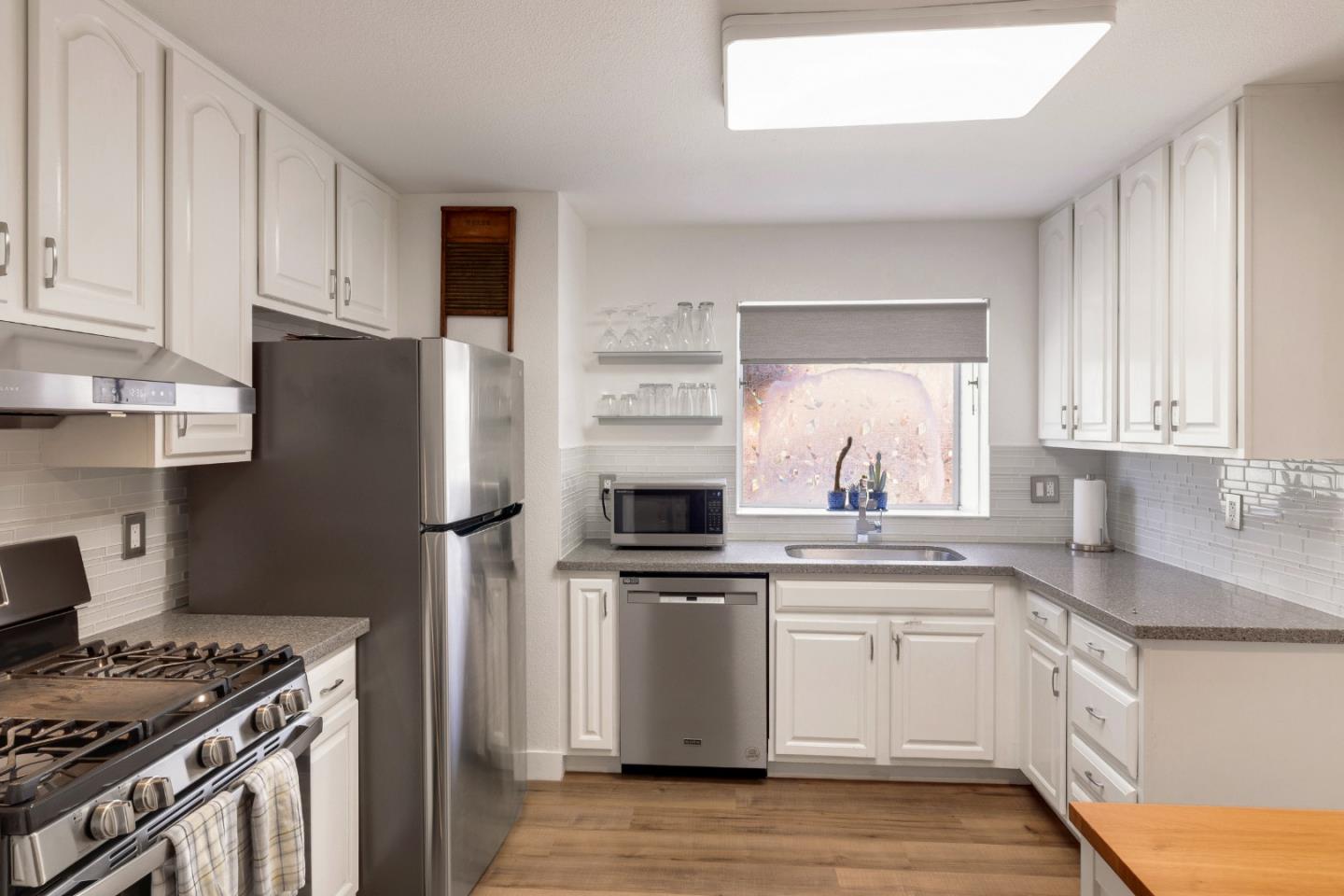 174 Pacific Avenue Pacifica, CA 94044 - Photo 13 of 31 a kitchen with a stove top oven sink and refrigerator