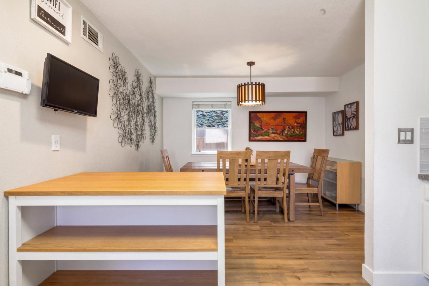 174 Pacific Avenue Pacifica, CA 94044 - Photo 15 of 31 a workspace with furniture and flat screen tv