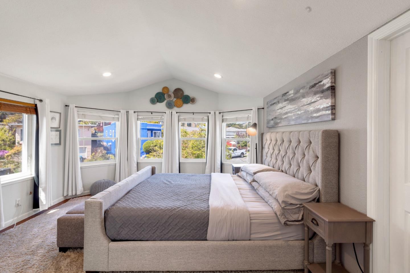 174 Pacific Avenue Pacifica, CA 94044 - Photo 16 of 31 a bedroom with a large bed and a large window