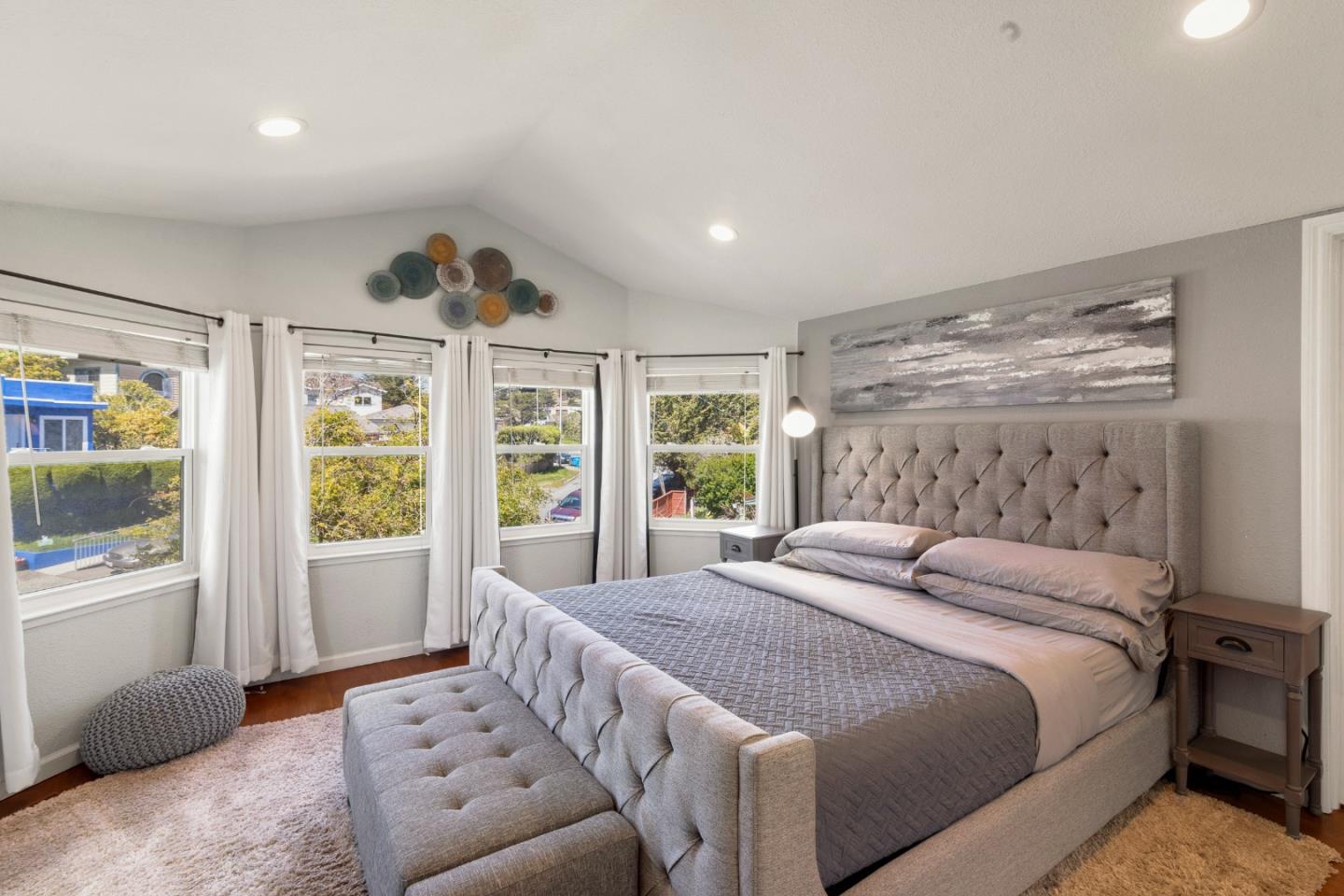 174 Pacific Avenue Pacifica, CA 94044 - Photo 17 of 31 a spacious bedroom with a large bed and a large window