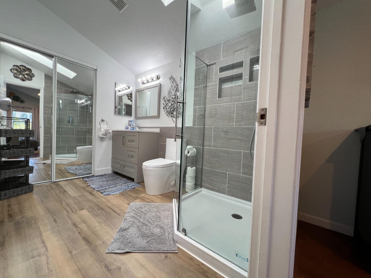 174 Pacific Avenue Pacifica, CA 94044 - Photo 19 of 31 a bathroom with a granite countertop sink a mirror and shower