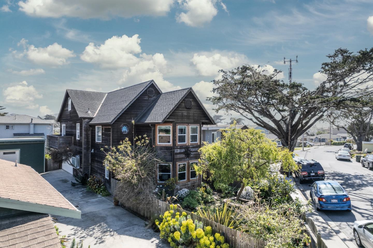 174 Pacific Avenue Pacifica, CA 94044 - Photo 27 of 31 a front view of a house with a garden