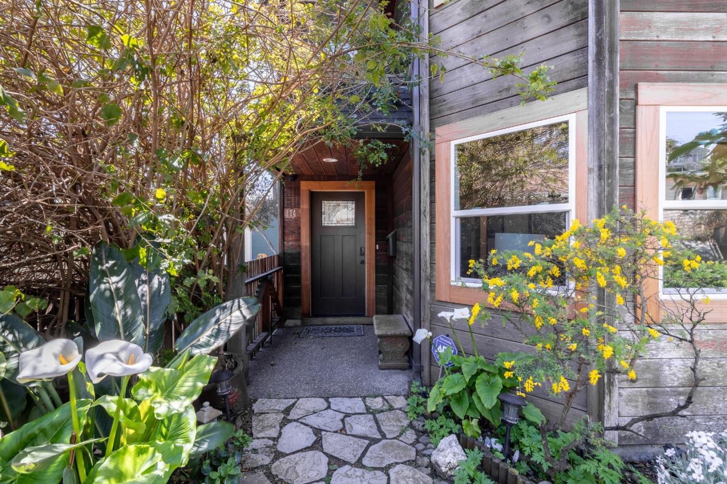 174 Pacific Avenue Pacifica, CA 94044 - Photo 4 of 31 a front view of a house with a garden