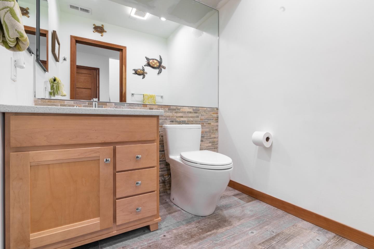 174 Pacific Avenue Pacifica, CA 94044 - Photo 10 of 31 a bathroom with a toilet a sink and mirror