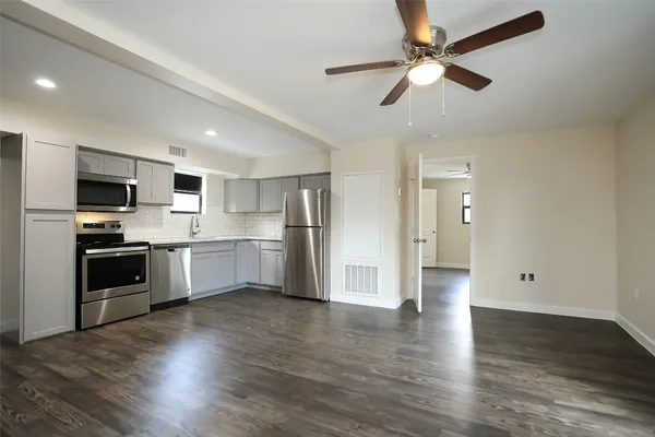 a view of kitchen with sink microwave and refrigerator