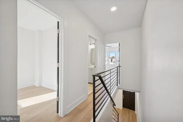 a view of a hallway with wooden floor and entryway