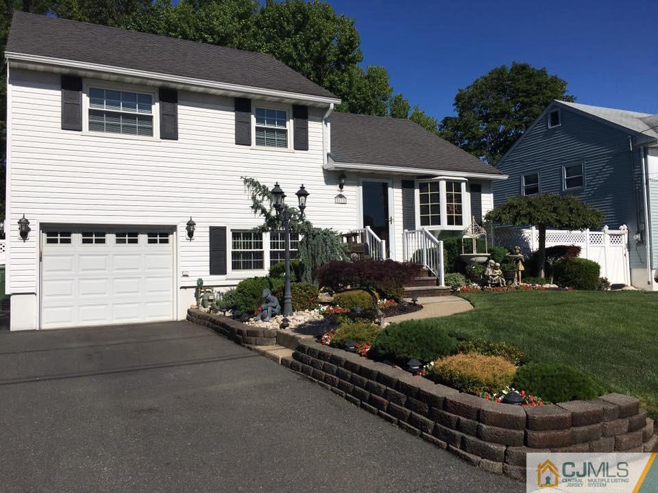 17 Wilshire Road Edison, NJ 08817 - Photo 1 of 19 a front view of a house with a yard and garage
