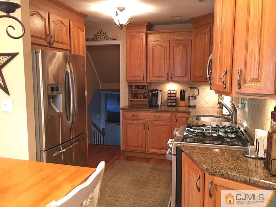 17 Wilshire Road Edison, NJ 08817 - Photo 3 of 19 a kitchen with stainless steel appliances granite countertop a refrigerator a stove and a sink