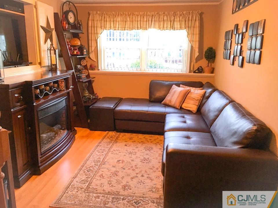 17 Wilshire Road Edison, NJ 08817 - Photo 5 of 19 a living room with furniture and a fireplace